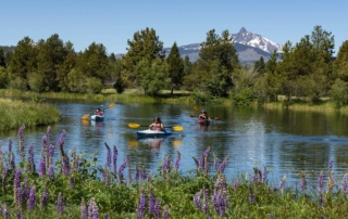 People kayaking, one of the best water activities in Central Oregon.